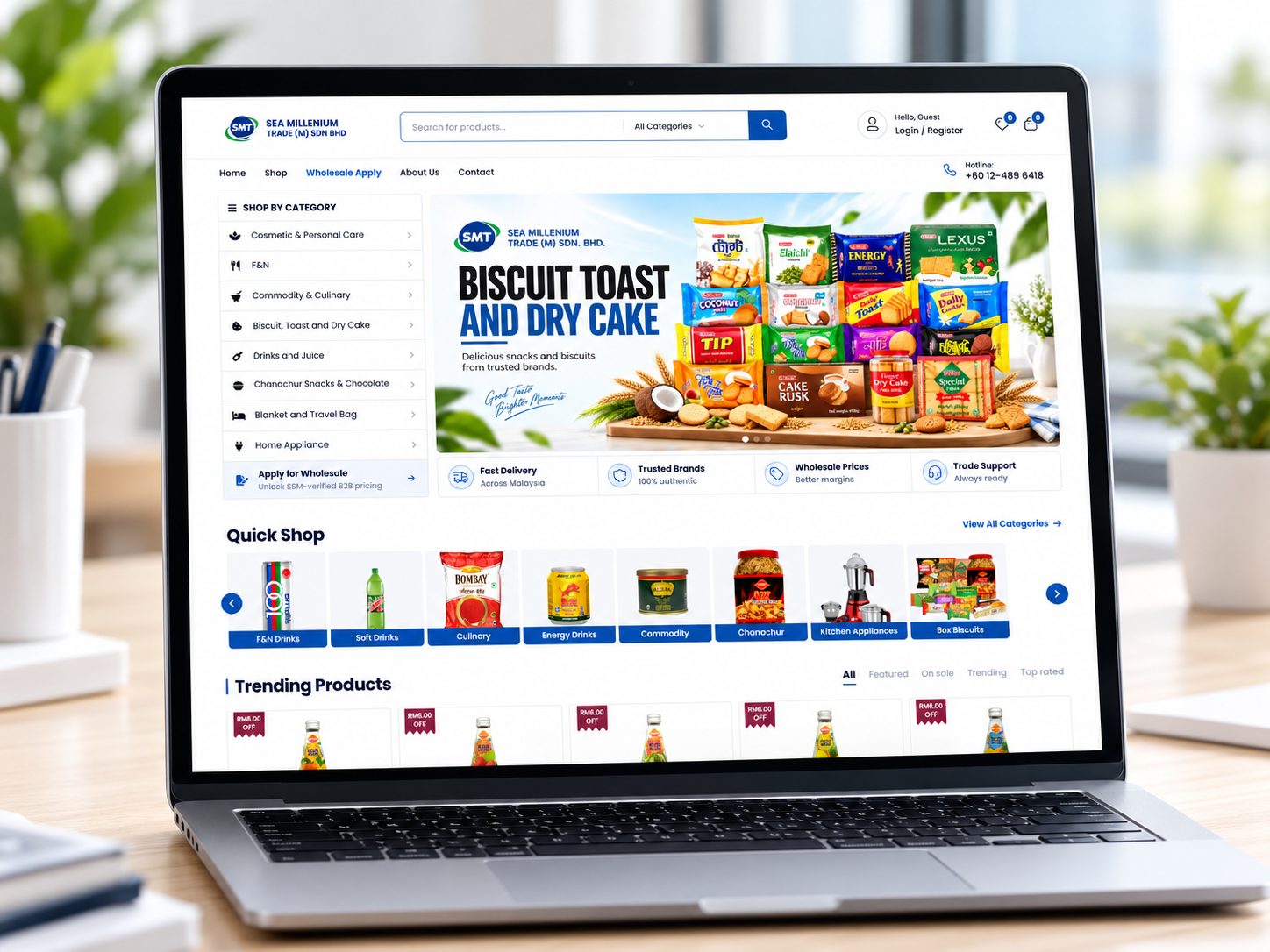 The SMT online store open on a laptop, showing biscuits, toast, and dry cake